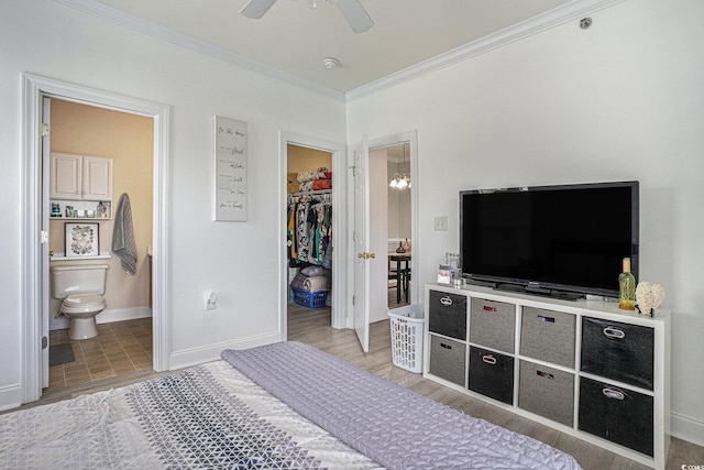 2005 Silvercrest Dr Unit 32F, Myrtle Beach, SC 29579 - bedroom featuring a walk in closet, crown molding, connected bathroom, wood finished floors, and a closet