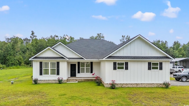4486 Bethel Rd, Aynor, SC 29511 - view of front facade with roof with shingles, covered porch, a front yard, and board and batten siding