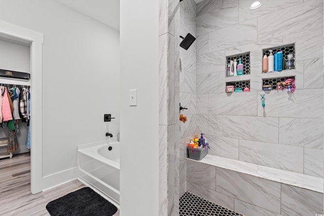 4486 Bethel Rd, Aynor, SC 29511 - bathroom featuring tiled shower, wood finished floors, and a tub