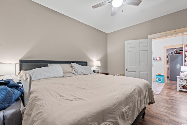 4486 Bethel Rd, Aynor, SC 29511 - bedroom with vaulted ceiling, wood finished floors, freestanding refrigerator, and a ceiling fan