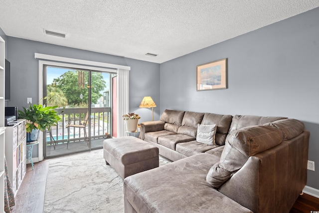 7700 Porcher Dr Unit 3205, Myrtle Beach, SC 29572 - living room with wood finished floors and a textured ceiling