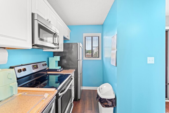 7700 Porcher Dr Unit 3205, Myrtle Beach, SC 29572 - kitchen with appliances with stainless steel finishes, white cabinets, dark wood-type flooring, and light countertops