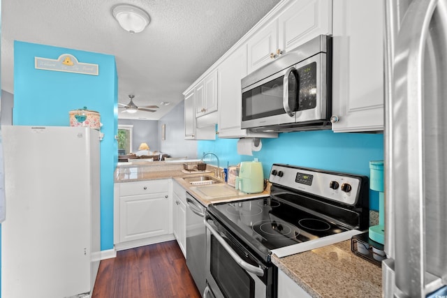 7700 Porcher Dr Unit 3205, Myrtle Beach, SC 29572 - kitchen featuring appliances with stainless steel finishes, dark wood finished floors, white cabinetry, a ceiling fan, and a textured ceiling