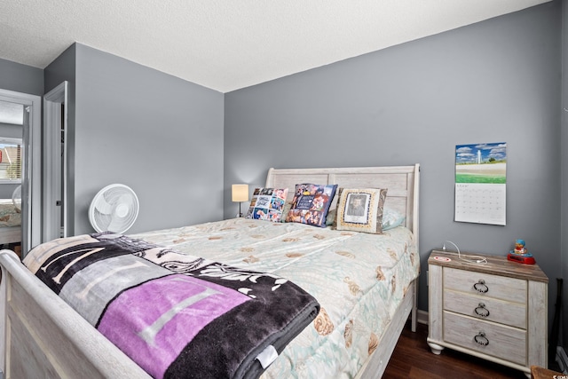7700 Porcher Dr Unit 3205, Myrtle Beach, SC 29572 - bedroom featuring dark wood finished floors and a textured ceiling