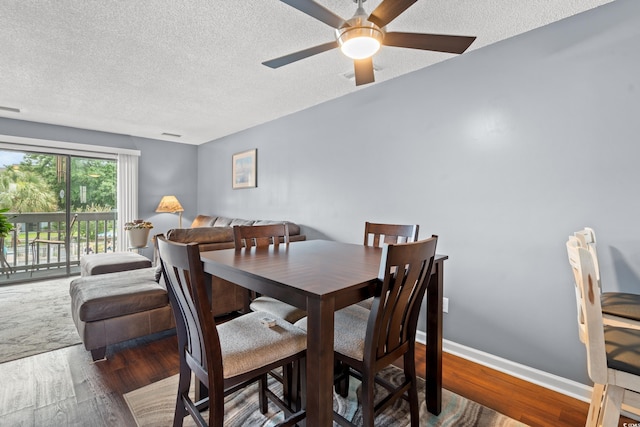7700 Porcher Dr Unit 3205, Myrtle Beach, SC 29572 - dining space featuring wood finished floors, a textured ceiling, and a ceiling fan