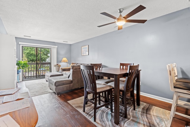 7700 Porcher Dr Unit 3205, Myrtle Beach, SC 29572 - dining space with a textured ceiling, wood finished floors, and ceiling fan
