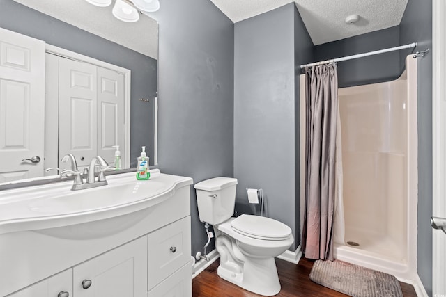 7700 Porcher Dr Unit 3205, Myrtle Beach, SC 29572 - bathroom featuring vanity, wood finished floors, a shower with shower curtain, and a textured ceiling