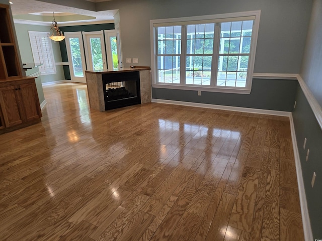 6542 Wellington Dr, Murrells Inlet, SC 29576 - unfurnished living room featuring wood finished floors, crown molding, and a multi sided fireplace