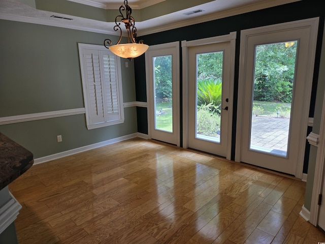 6542 Wellington Dr, Murrells Inlet, SC 29576 - unfurnished dining area with ornamental molding, wood finished floors, and a tray ceiling