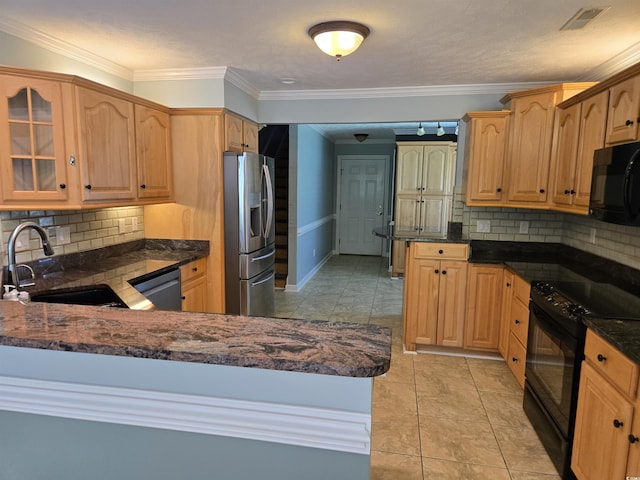 6542 Wellington Dr, Murrells Inlet, SC 29576 - kitchen with black appliances, a peninsula, decorative backsplash, dark stone counters, and crown molding