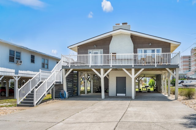 204 55th Ave N, North Myrtle Beach, SC 29582 - beach home with a carport, concrete driveway, a chimney, and stairs