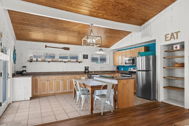 204 55th Ave N, North Myrtle Beach, SC 29582 - kitchen with stainless steel appliances, wood ceiling, dark countertops, lofted ceiling, and light tile patterned flooring