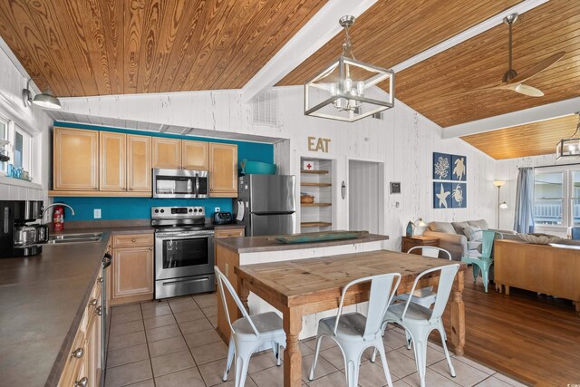 204 55th Ave N, North Myrtle Beach, SC 29582 - kitchen with stainless steel appliances, wood ceiling, tile patterned floors, dark countertops, and open floor plan