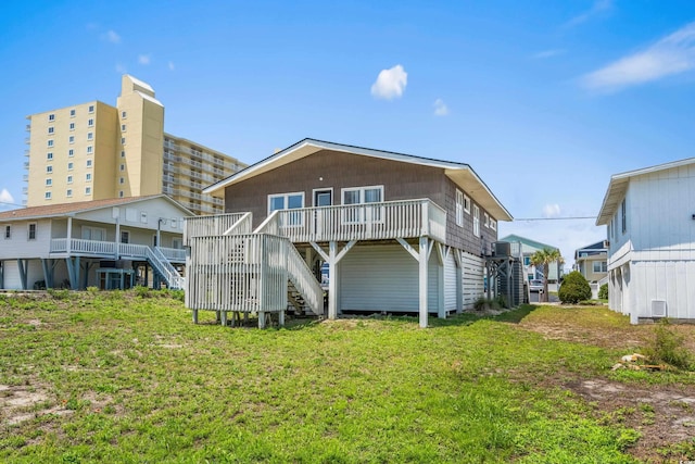 204 55th Ave N, North Myrtle Beach, SC 29582 - back of house featuring stairs, a deck, and a lawn