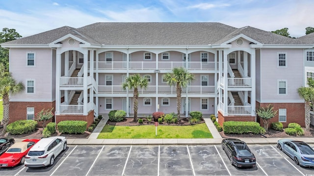 4142 Hibiscus Dr Unit 102, Little River, SC 29566 - view of building exterior with uncovered parking and stairway