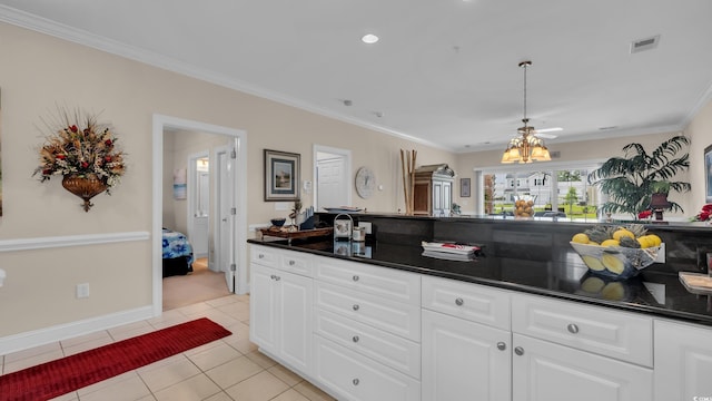 4142 Hibiscus Dr Unit 102, Little River, SC 29566 - kitchen featuring dark countertops, light tile patterned floors, crown molding, white cabinetry, and recessed lighting