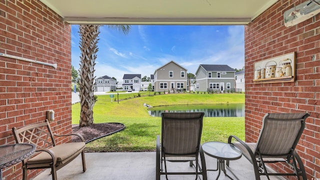 4142 Hibiscus Dr Unit 102, Little River, SC 29566 - view of patio / terrace with a residential view and a water view