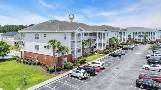 4142 Hibiscus Dr Unit 102, Little River, SC 29566 - view of building exterior with uncovered parking and a residential view