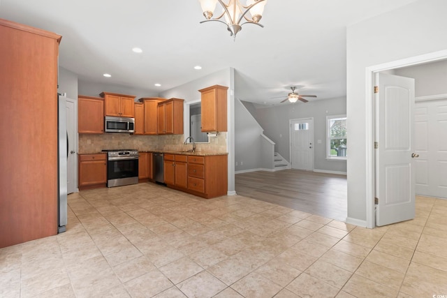 1448 Tiger Grand Dr, Conway, SC 29526 - kitchen with stainless steel appliances, tasteful backsplash, open floor plan, a chandelier, and light tile patterned flooring
