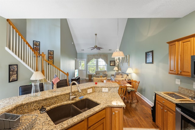 100 Culpepper Way Unit 1003, Myrtle Beach, SC 29579 - kitchen with dark wood-style flooring, brown cabinets, ceiling fan, and high vaulted ceiling