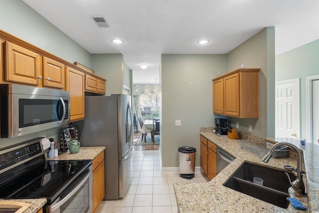 100 Culpepper Way Unit 1003, Myrtle Beach, SC 29579 - kitchen with appliances with stainless steel finishes, light stone countertops, and light tile patterned floors