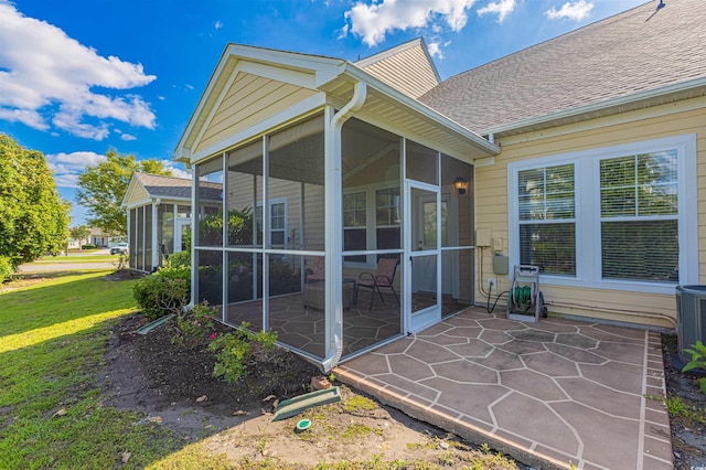 100 Culpepper Way Unit 1003, Myrtle Beach, SC 29579 - rear view of house featuring a sunroom, a patio area, roof with shingles, and a lawn