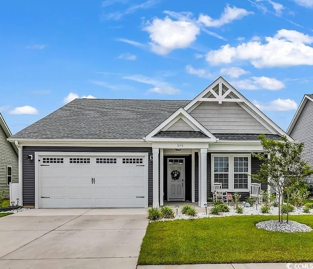 1898 Moonseed Dr, Longs, SC 29568 - view of front of property with concrete driveway, a front yard, an attached garage, covered porch, and roof with shingles