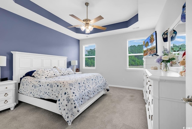 1898 Moonseed Dr, Longs, SC 29568 - bedroom featuring light colored carpet, a tray ceiling, and a ceiling fan