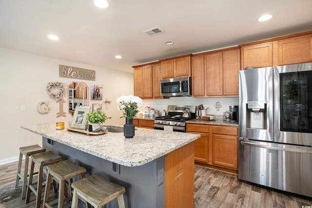 247GROVEPARK Grove Park Loop, Murrells Inlet, SC 29576 - kitchen with stainless steel appliances, wood finished floors, a kitchen bar, light stone counters, and recessed lighting