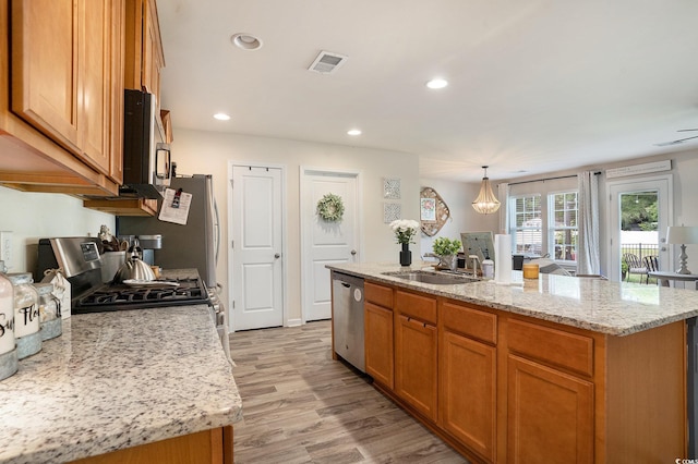 247GROVEPARK Grove Park Loop, Murrells Inlet, SC 29576 - kitchen with appliances with stainless steel finishes, a kitchen island with sink, light wood-style floors, recessed lighting, and light stone counters