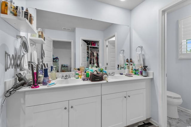 1078 Saltgrass Way, Myrtle Beach, SC 29588 - bathroom with double vanity, marble look tile flooring, and a spacious closet