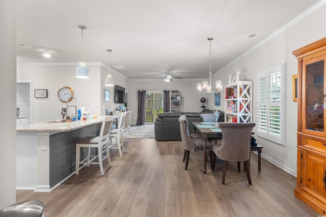 1078 Saltgrass Way, Myrtle Beach, SC 29588 - dining area featuring a ceiling fan, ornamental molding, light wood-type flooring, and a chandelier