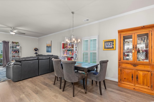 1078 Saltgrass Way, Myrtle Beach, SC 29588 - dining room featuring light wood-style flooring, ornamental molding, a chandelier, and ceiling fan