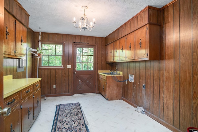 4920 Meadow St, Loris, SC 29569 - laundry room with cabinet space, a chandelier, wooden walls, a textured ceiling, and electric dryer hookup