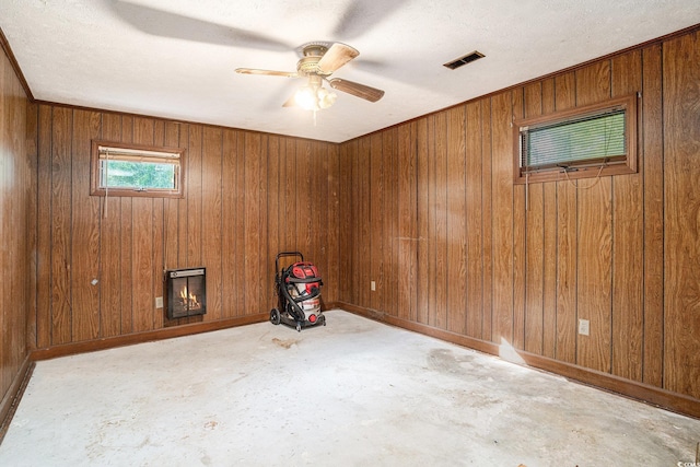 4920 Meadow St, Loris, SC 29569 - unfurnished room featuring concrete floors, wood walls, a ceiling fan, and a textured ceiling