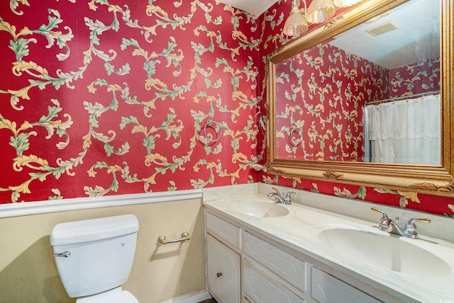 4920 Meadow St, Loris, SC 29569 - bathroom with wallpapered walls and double vanity