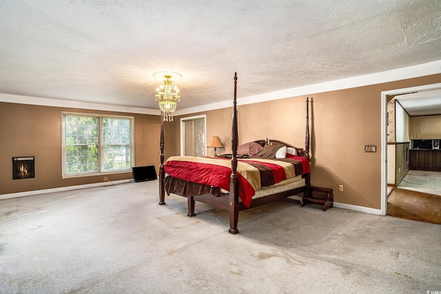 4920 Meadow St, Loris, SC 29569 - bedroom featuring carpet flooring, a chandelier, a textured ceiling, and a warm lit fireplace