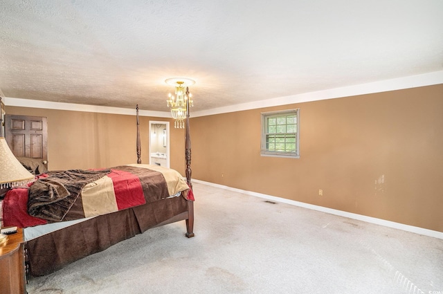 4920 Meadow St, Loris, SC 29569 - carpeted bedroom featuring a chandelier, ensuite bath, and a textured ceiling