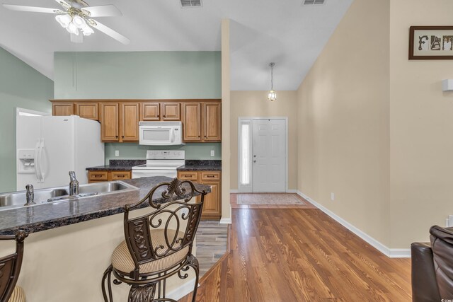 1206 Formby Ct, Myrtle Beach, SC 29588 - kitchen with white appliances, a ceiling fan, high vaulted ceiling, light wood-style flooring, and brown cabinets