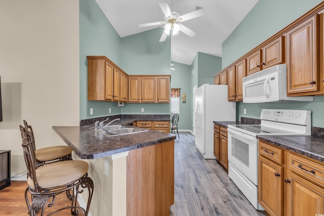 1206 Formby Ct, Myrtle Beach, SC 29588 - kitchen with white appliances, a peninsula, high vaulted ceiling, dark countertops, and a breakfast bar area