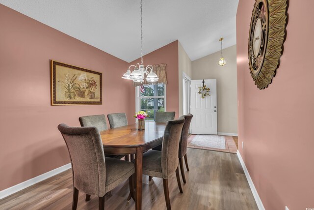 1206 Formby Ct, Myrtle Beach, SC 29588 - dining room featuring vaulted ceiling, wood finished floors, and a chandelier