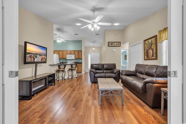 1206 Formby Ct, Myrtle Beach, SC 29588 - living area featuring high vaulted ceiling, a ceiling fan, and light wood-type flooring