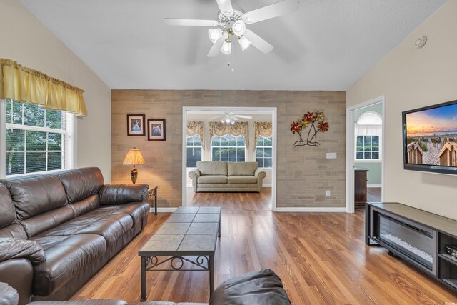 1206 Formby Ct, Myrtle Beach, SC 29588 - living room with an accent wall, a ceiling fan, lofted ceiling, and healthy amount of natural light