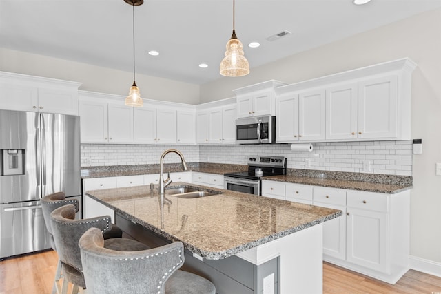 3617 Pasture Rd, Aynor, SC 29511 - kitchen featuring appliances with stainless steel finishes, white cabinetry, light wood finished floors, and recessed lighting