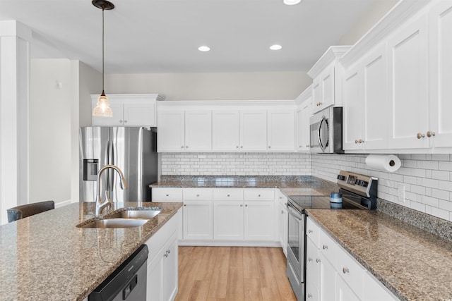 3617 Pasture Rd, Aynor, SC 29511 - kitchen with appliances with stainless steel finishes, white cabinetry, pendant lighting, light wood-style floors, and tasteful backsplash