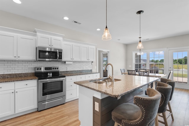 3617 Pasture Rd, Aynor, SC 29511 - kitchen featuring appliances with stainless steel finishes, tasteful backsplash, white cabinetry, light wood-style flooring, and recessed lighting
