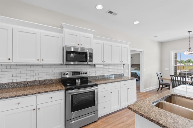 3617 Pasture Rd, Aynor, SC 29511 - kitchen with stainless steel appliances, light wood-type flooring, white cabinets, backsplash, and recessed lighting