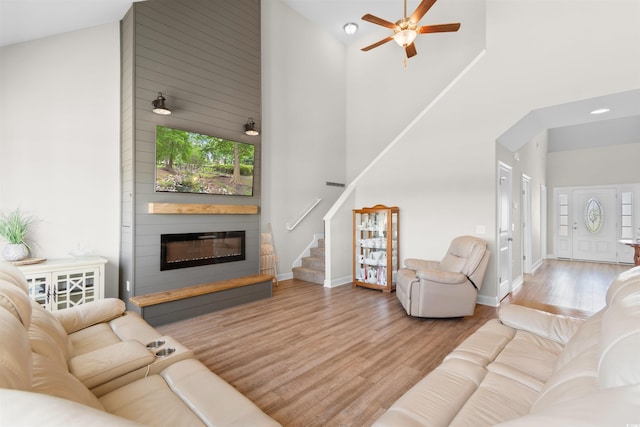 3617 Pasture Rd, Aynor, SC 29511 - living area with a high ceiling, a fireplace, stairs, wood finished floors, and a ceiling fan