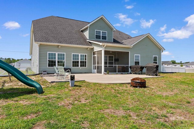 3617 Pasture Rd, Aynor, SC 29511 - back of house featuring a fire pit, a sunroom, a patio area, a shingled roof, and a playground