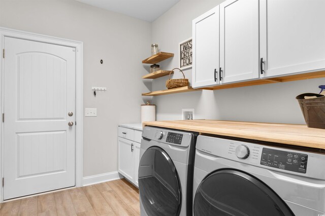 3617 Pasture Rd, Aynor, SC 29511 - laundry area featuring independent washer and dryer, cabinet space, and light wood-style flooring